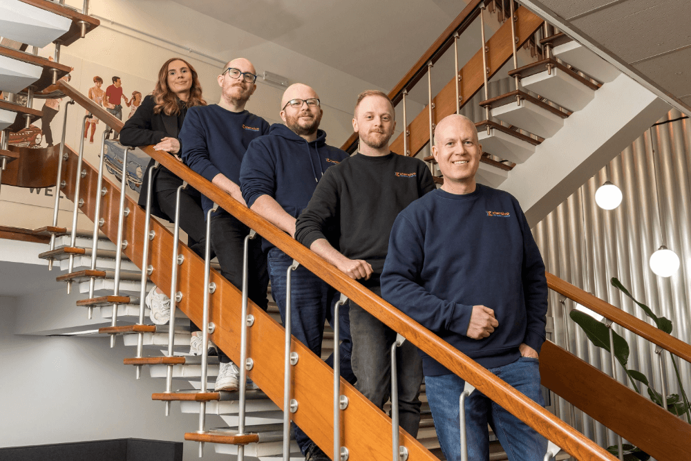 the xtensive team standing on a flight of stairs